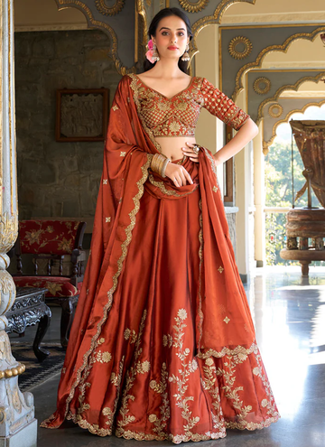 Draped in Rust, glowing in glow silk lehenga with zari, thread sequin work.
